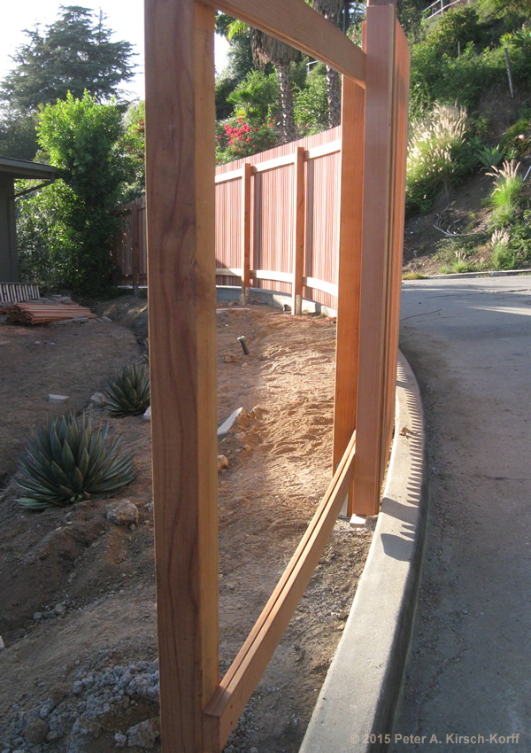 Photo of Los Angeles Curved, Sloped Vertical Slat Redwood Fenceunder construction before staining in Hollywood Hills,CA