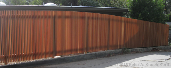Photo of Los Angeles Curved Vertical Slat Redwood Fence with top curve following uphill slope in Hollywood Hills,CA